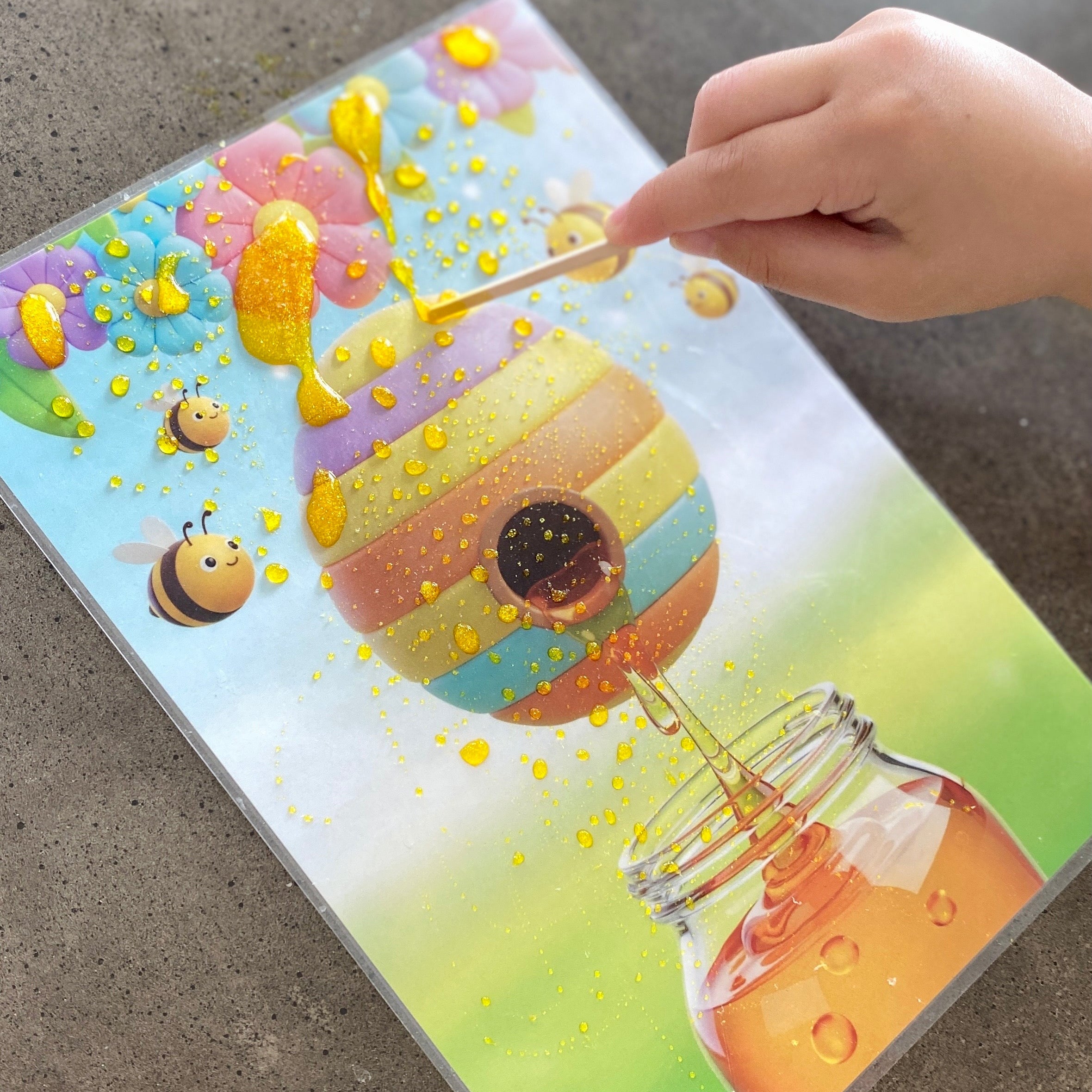 Child playing with magic potion elixir and learning about how bees make honey. Learning through play sensory play to develop fine motor skills.